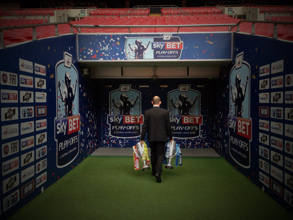Chris Rivett takes the Sky Bet Play-Off final trophies back into the dressing rooms after a photo shoot at Wembley Stadium.